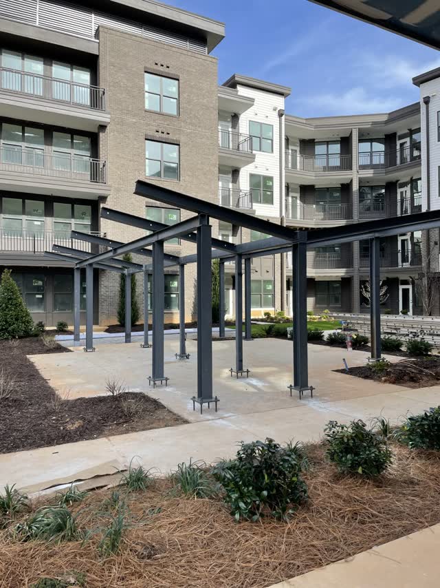 Steel courtyard pergolas installed between apartment buildings